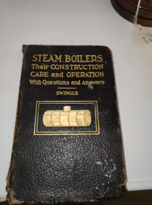 Black leather-bound book cover reading 'Steam Boilers: Their Construction, Care and Operation, With Questions and Answers' by Swingle, gold embossed with a boiler illustration.