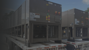 Two large industrial cooling units on flatbed trailers outdoors, ready for transport.