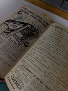 Vintage newspaper spread about Floyd Clymer's motor scrapbooks, with bold headlines and advertisements visible on angled pages.