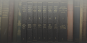 Row of old hardcover books titled Audels Engineers and Mechanics Guide, volumes 1–8 on a dark bookshelf