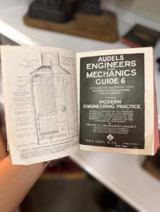Open booklet with a technical boiler diagram on the left and the 'Audels Engineers and Mechanics Guide 6' cover on the right.