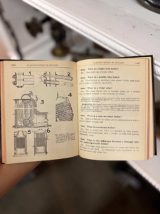 Open vintage technical book showing boiler diagrams on the left and text on the right page.