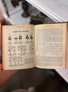 Open vintage manual showing diagrams and text about compound engines, including cylinder arrangements on left page and descriptive paragraphs on right page.