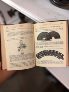 Open vintage technical manual showing steam turbine diagrams and labeled components.