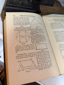 Open page of a vintage geometry book titled 'Hand Book of Calculations' with diagrams of triangles, circles, and a rectangle (figures 89–91) on page 144.