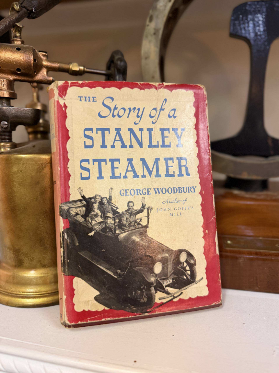 Old red hardcover book titled 'Triple Expansion Engines and Boilers' by A. Ritchie Leask, with vintage engine parts in the background.